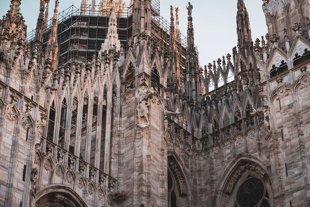 Detailed view of the Milan Cathedral's stunning Gothic architecture during daylight.