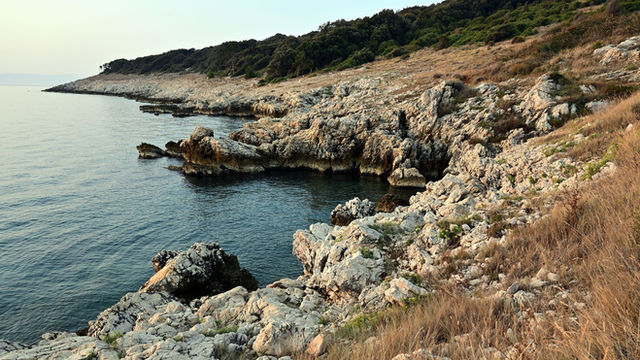 Stunning rocky shoreline at Duga Luka, Croatia, showcasing natural beauty and tranquility.