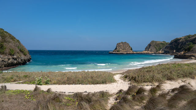 Discover the serene beauty of a serene beach in Lombok, Indonesia, with turquoise waters and sandy shores.