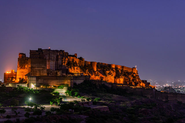 The fort floodlit above the plain at night