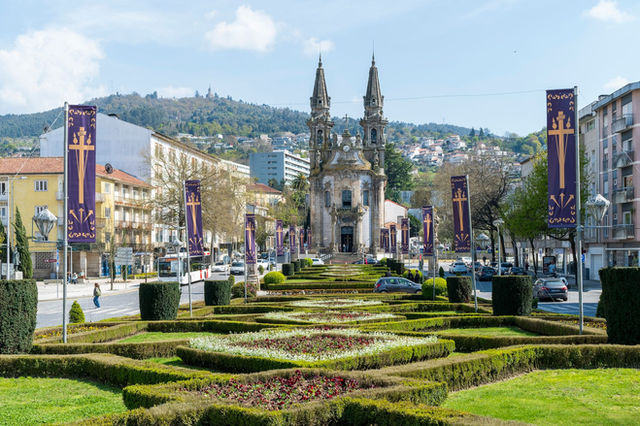 Explore the elegant architecture and landscaped gardens of Guimarães' historic church in Portugal.