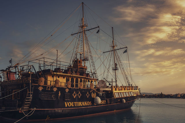 Captivating view of a vintage ship docked in Zakynthos, Greece, during sunset with a scenic sky.