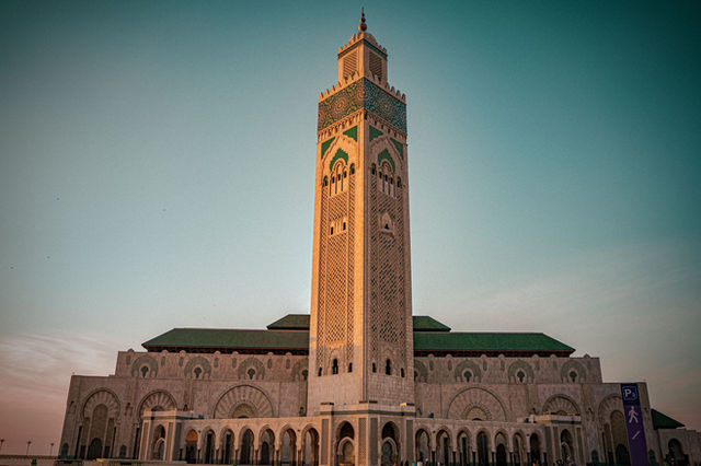 The majestic Hassan II Mosque in Casablanca, Morocco, beautifully lit at sunset.