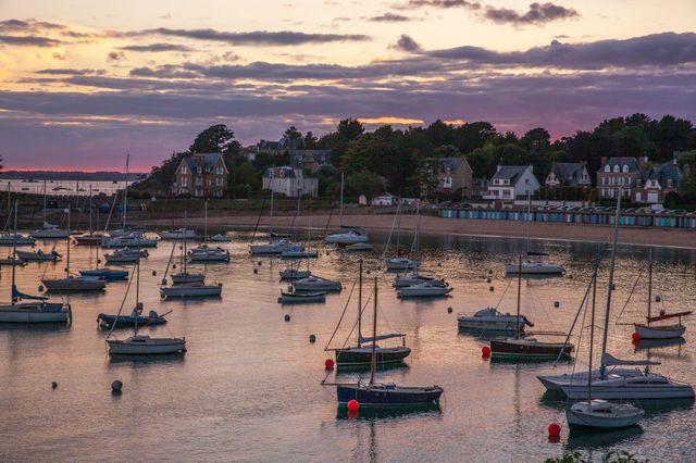 Beautiful sunset view of sailboats in Saint Briac Sur Mer harbor, Brittany, France.