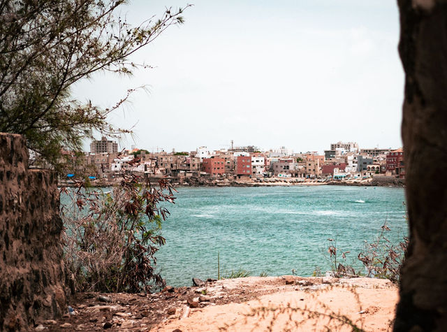 Discover the vibrant colors and unique architecture of a coastal town in Senegal with this scenic view.