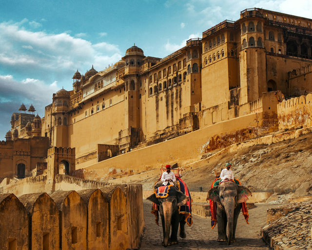 Two elephants carry riders up the Amber ramp