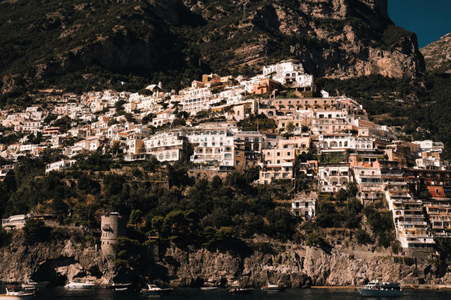 A stunning view of the Amalfi Coast with picturesque buildings perched on steep cliffs.