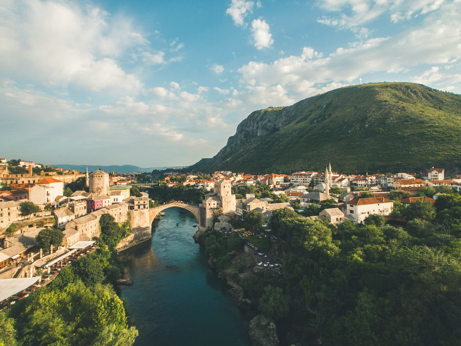 Mostar is a picturesque city in Bosnia and Herzegovina that is quite literally split into two religions—Islam on one side of the river bank and Catholicism on the other. The bridge pictured here, for