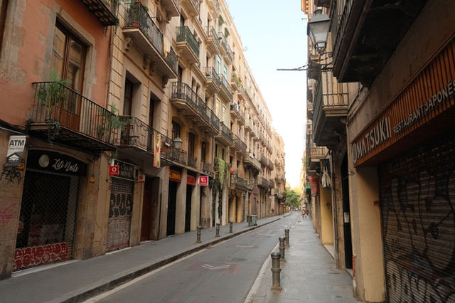 Charming view of a quiet Barcelona street showcasing classic European architecture and urban scenery.