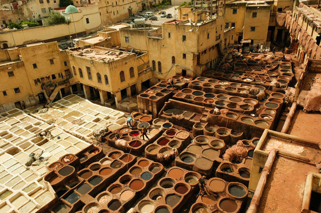 Aerial view of the historic leather tannery in Fes, Morocco, showcasing traditional dyeing vats.