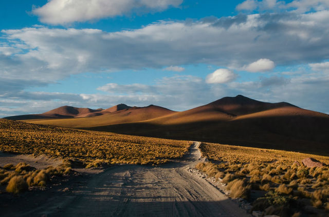 Explore the stunning desert hills of Potosi, Bolivia under a clear blue sky. Perfect for adventure and travel lovers.