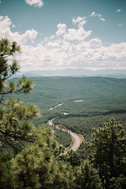 a scenic view of a winding road in the mountains
