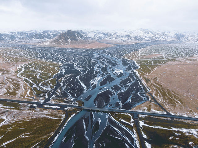 an aerial view of a river running through a valley