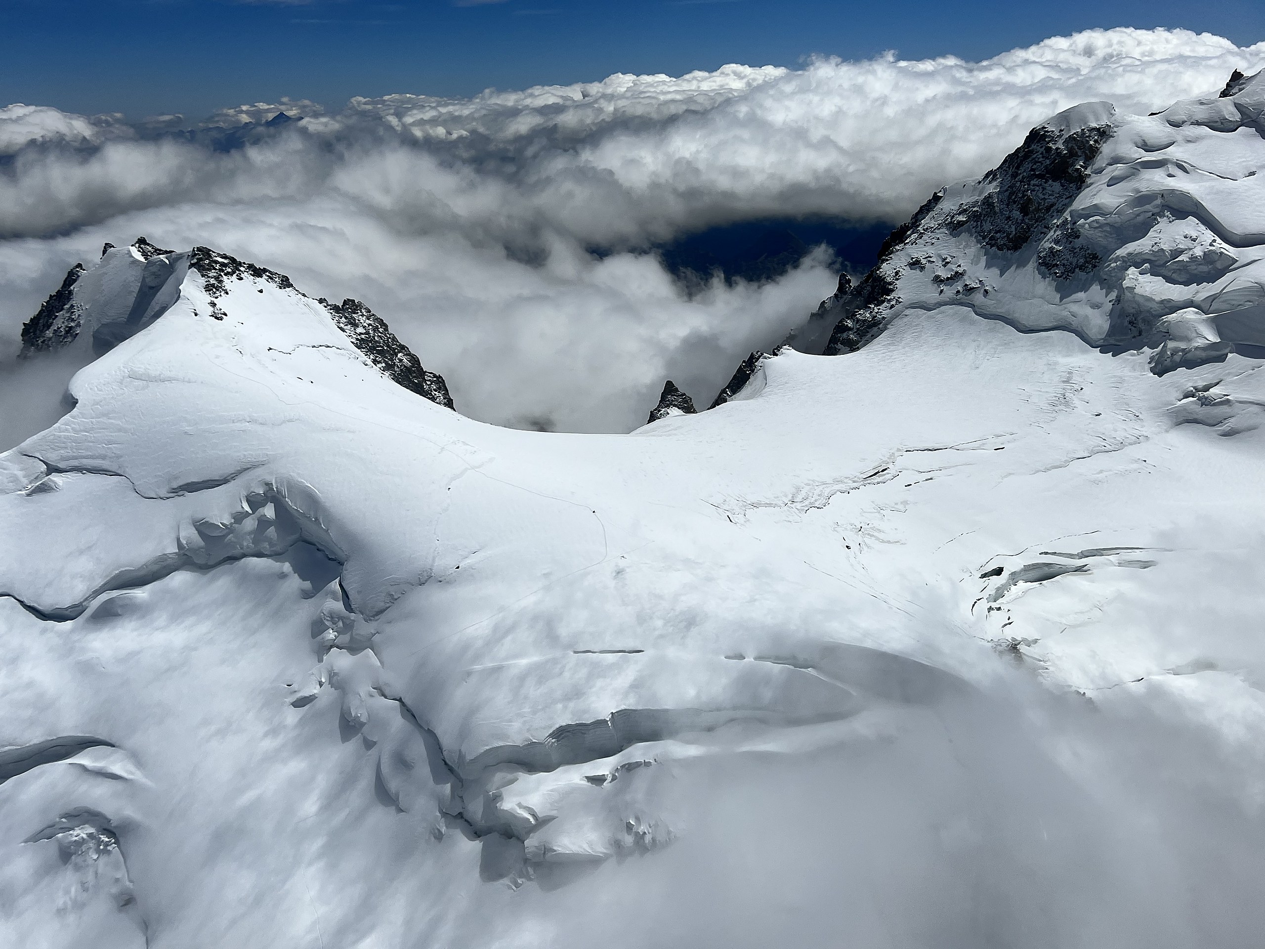 Snow-covered summits above the clouds in the Mont Blanc massif, Chamonix