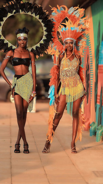 Two dancers in feathered headdresses — the Ekikumba fashion carnival