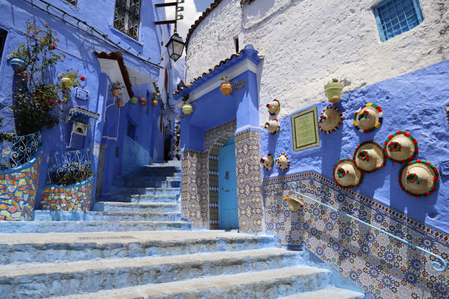 Explore the captivating blue streets of Chefchaouen, adorned with colorful pottery and traditional tiles.