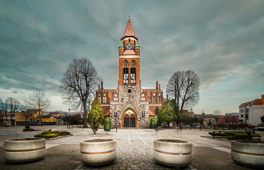 The center of a small city in Greater Poland. View of the church. European architecture in winter.