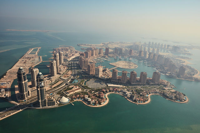 an aerial view of a city and a body of water