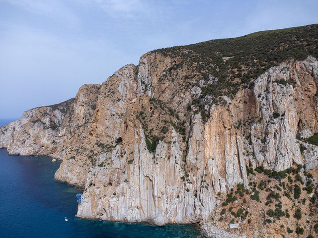 Stunning aerial view of the rugged coastal cliffs along the Mediterranean Sea in Sardinia, Italy.