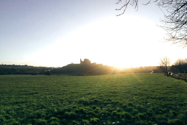 Castle silhouette on a hill at sunset