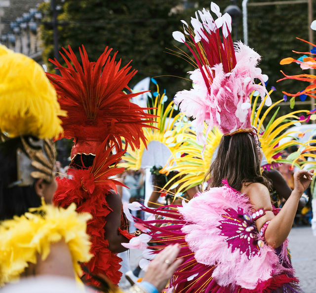 A press of headdresses, yellow into red into pink