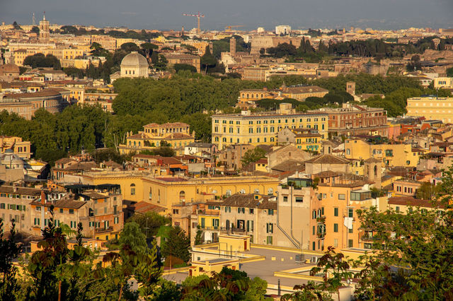 A stunning aerial view of Rome, showcasing its historic architecture under warm, golden light.