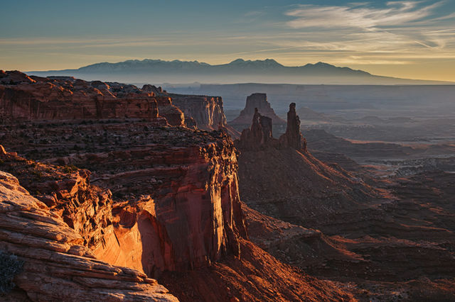 A scenic view of a mountain range at sunset