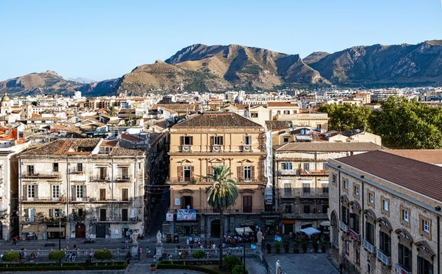 Stunning view of Palermo, Sicily with historical buildings and mountains in the background.