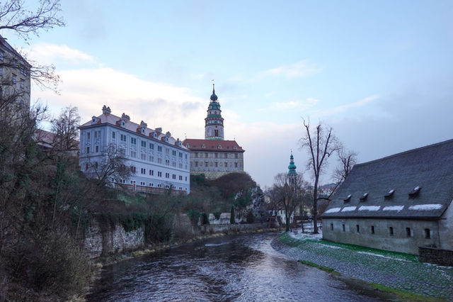 Scenic view of Český Krumlov Castle by the river during twilight in winter.