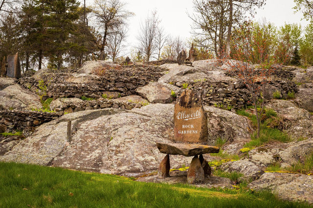 Photograph of landscape with large boulders and rock sculptures.