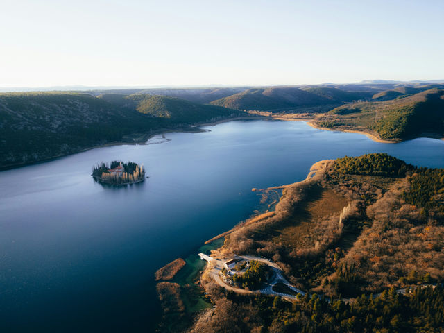 Island in a lake surrounded by croatian hills