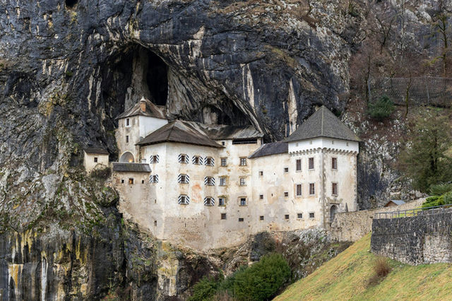 a castle built into the side of a cliff