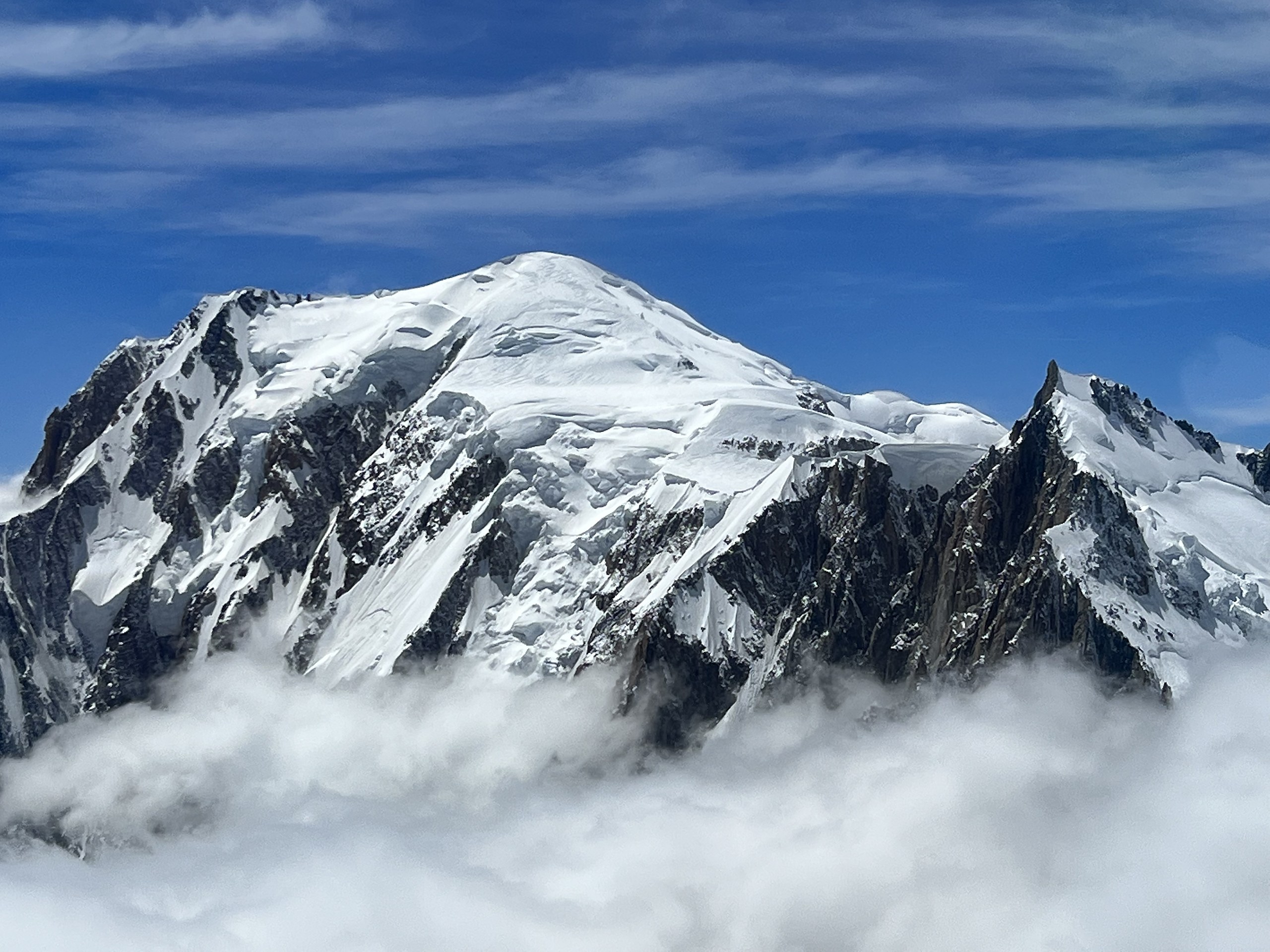 The snow dome of Mont Blanc rising above a sea of cloud, Chamonix