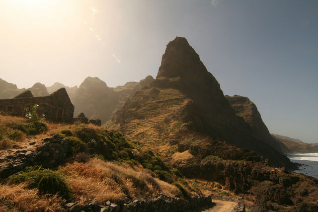 the sun shines brightly on a rocky coastline