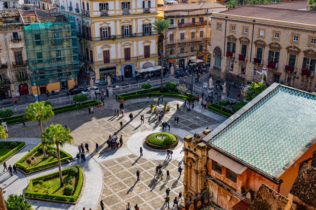 Charming historic piazza in Palermo, Sicily with people enjoying a sunny day.