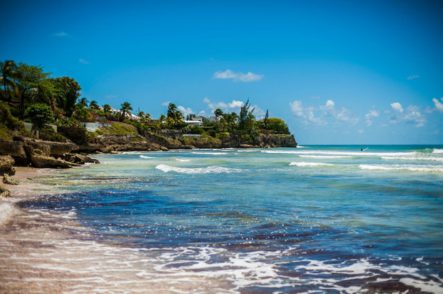 a sandy beach with waves coming in to shore