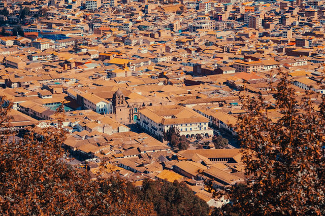 Stunning aerial view of Cusco's historic cityscape with prominent colonial architecture.
