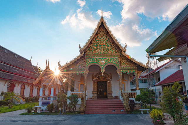 Beautiful ornate temple facade with sunburst at Wat Chiang Man, showcasing traditional Thai architecture.