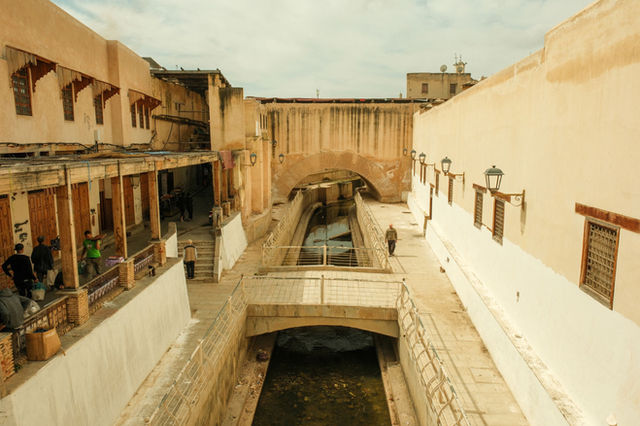 Explore the charming alleyways of Fes, Morocco featuring traditional architecture and vibrant street life.