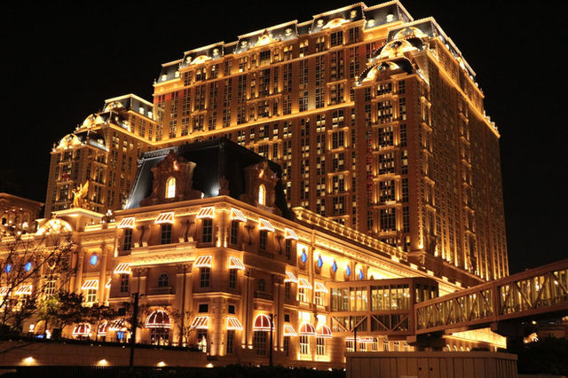 Spectacular night shot of the Parisian Macao Hotel, beautifully illuminated.