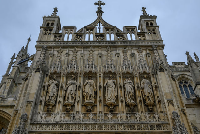 Intricate stone carvings on Bath Abbey's facade showcasing gothic architecture in England.