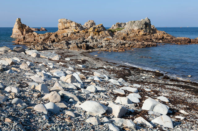 Explore the rugged beauty of Plougrescant's rocky coastline in Brittany, France.