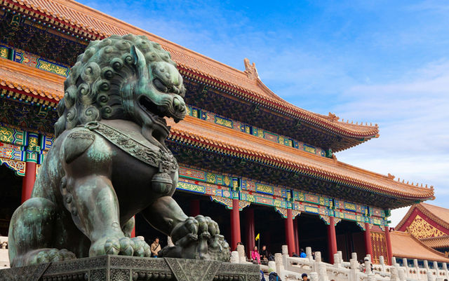 A bronze guardian lion statue before the Hall of Supreme Harmony in Beijing, China