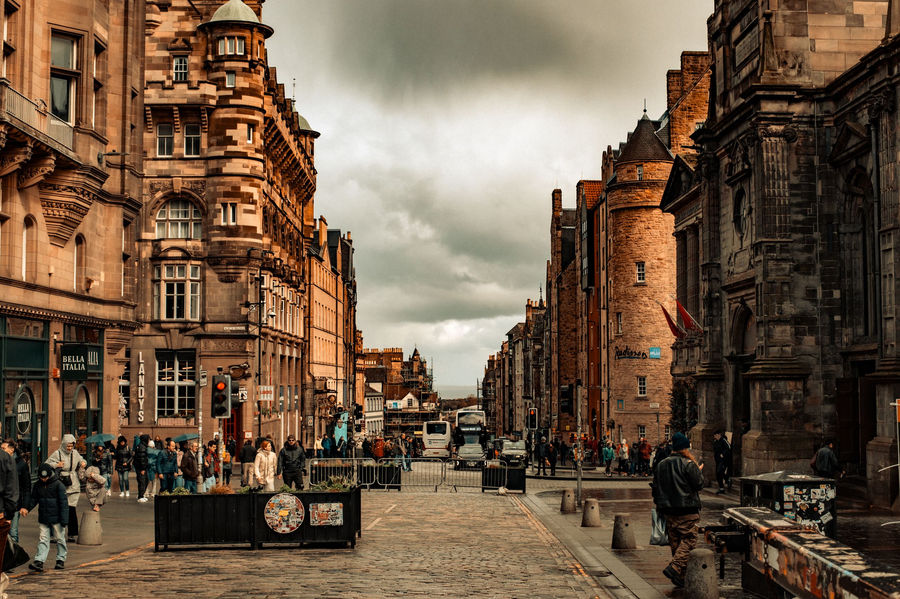 Capture of a bustling street in Edinburgh showcasing historic architecture and urban life.