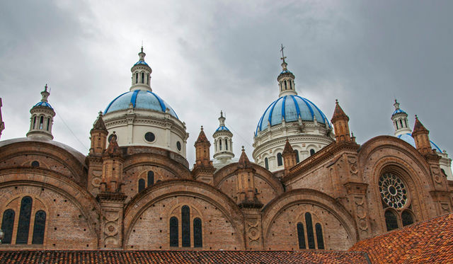 brown and white concrete dome building under gray clouds during daytime