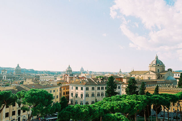 Explore the beautiful aerial view of Rome with its iconic architecture and lush greenery.