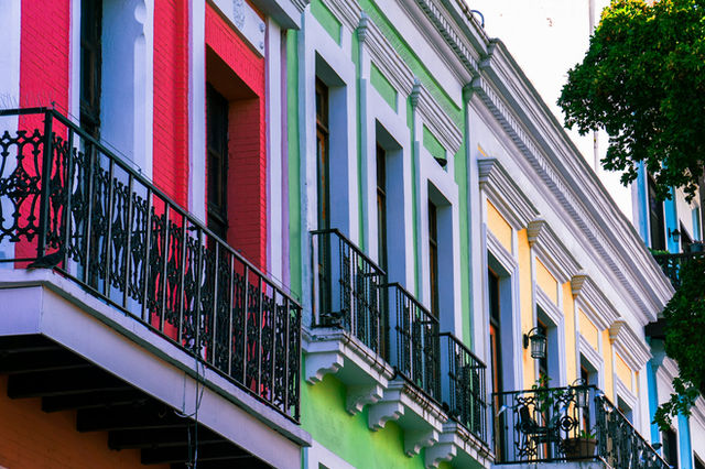 Colorful buildings with balconies and windows in a vibrant street