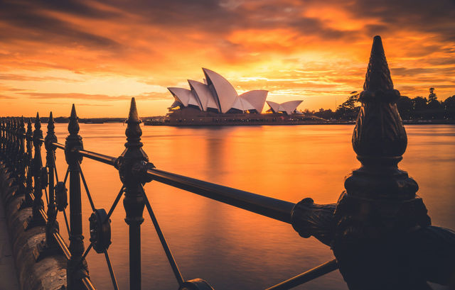 A stunning sunrise, captured behind the famous Sydney Opera House. 
Image taken at Circular Quay, Sydney, Australia.