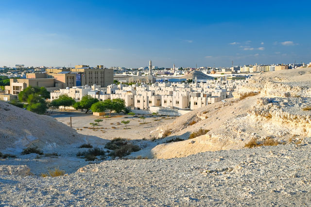 Cityscape of buildings on a clear, sunny day.