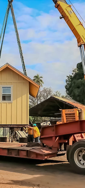 Moving a structure with a crane using heavy equipment on Kaua'i.